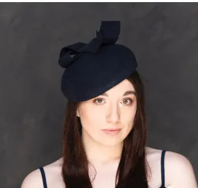 Navy beret with twist hatitnator.